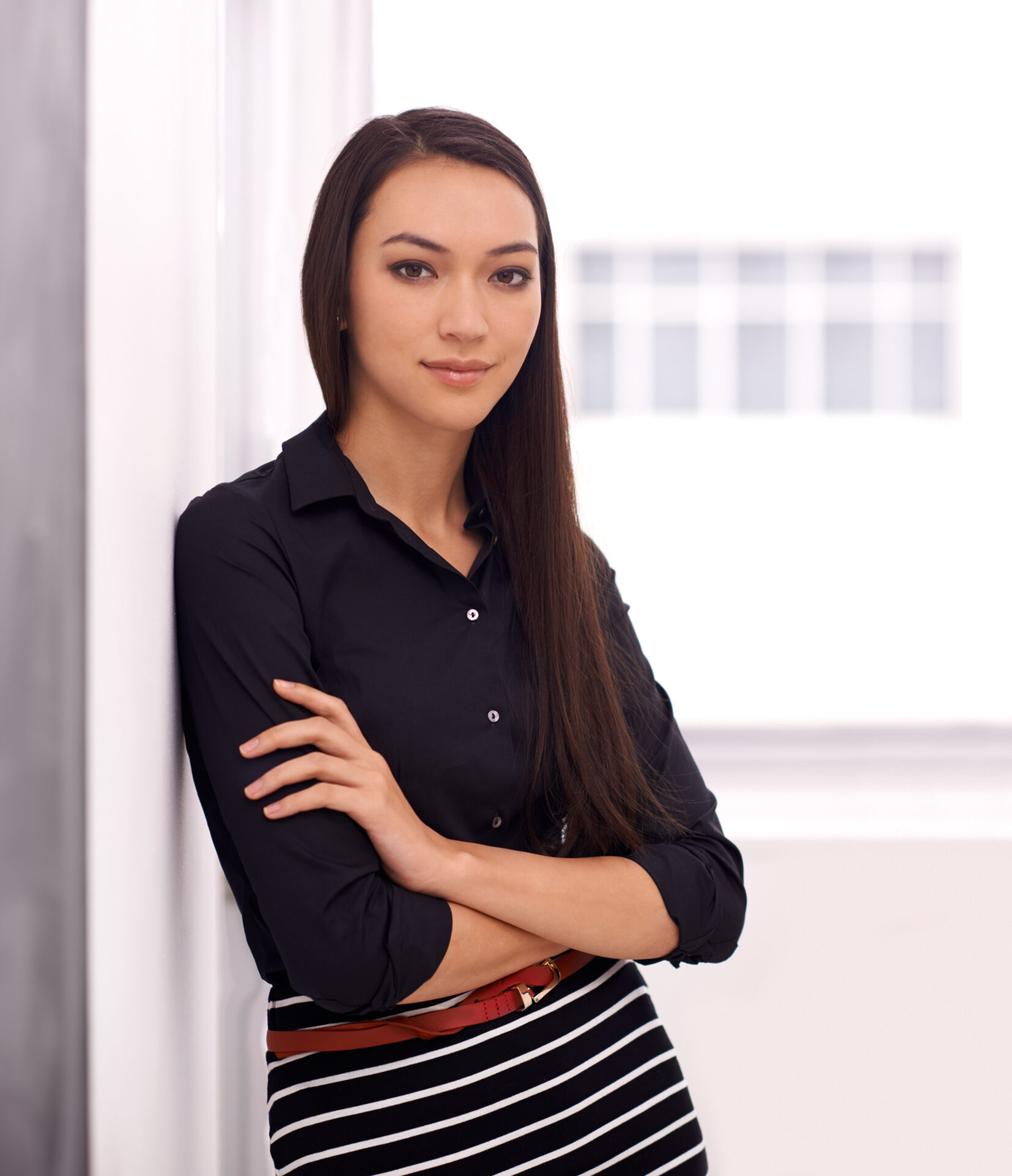 Living in a corporate world. Shot of a young businesswoman in her office